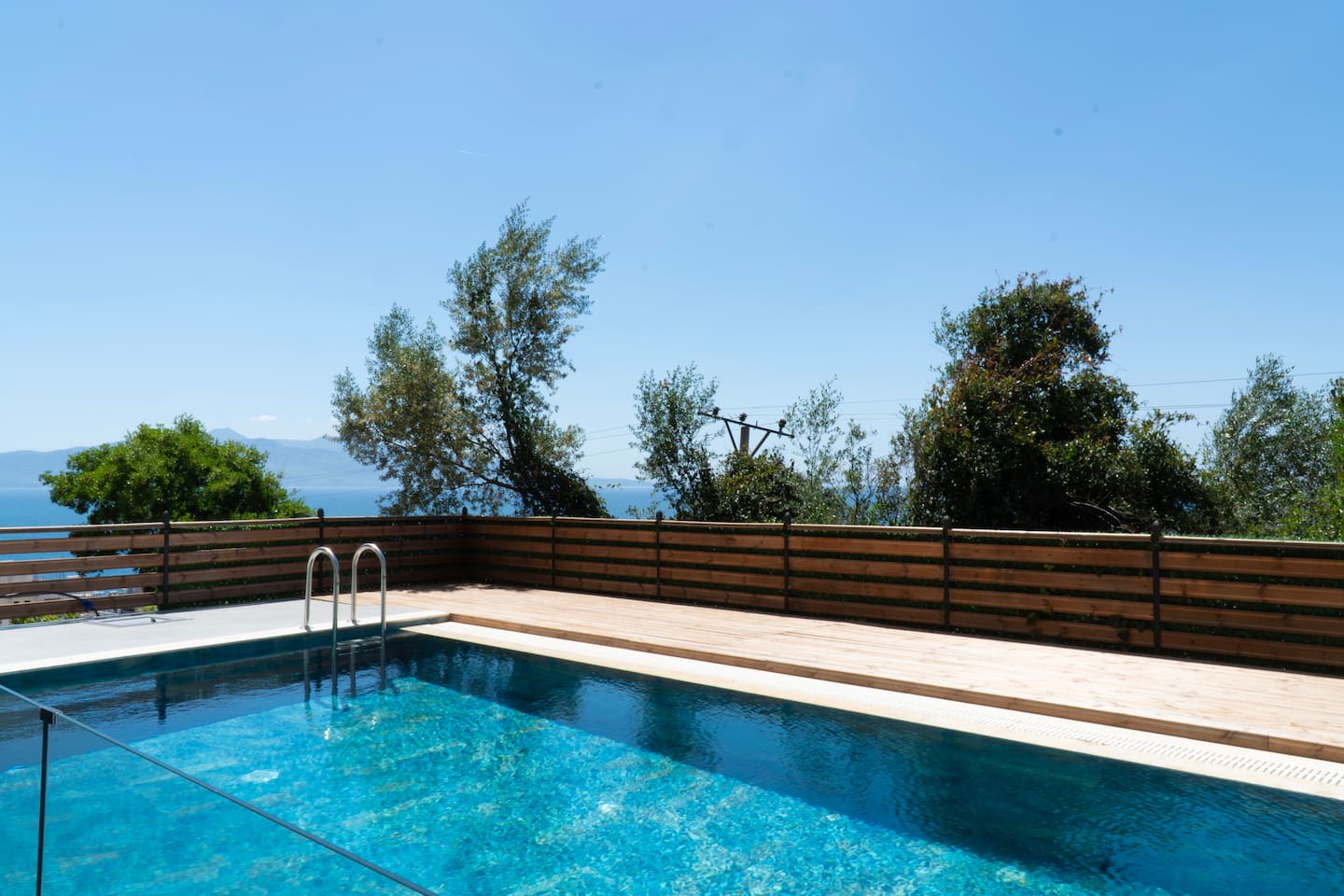 The pool framed by Mediterranean greenery